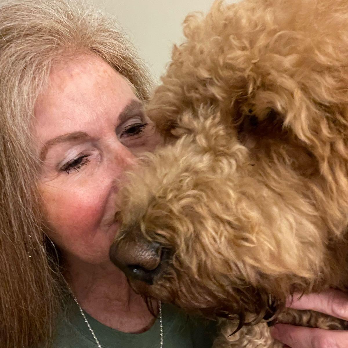 Diana close to a curly dog